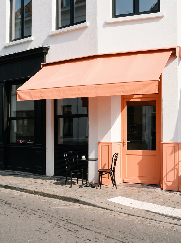 Corner café with a peach awning and a peach door